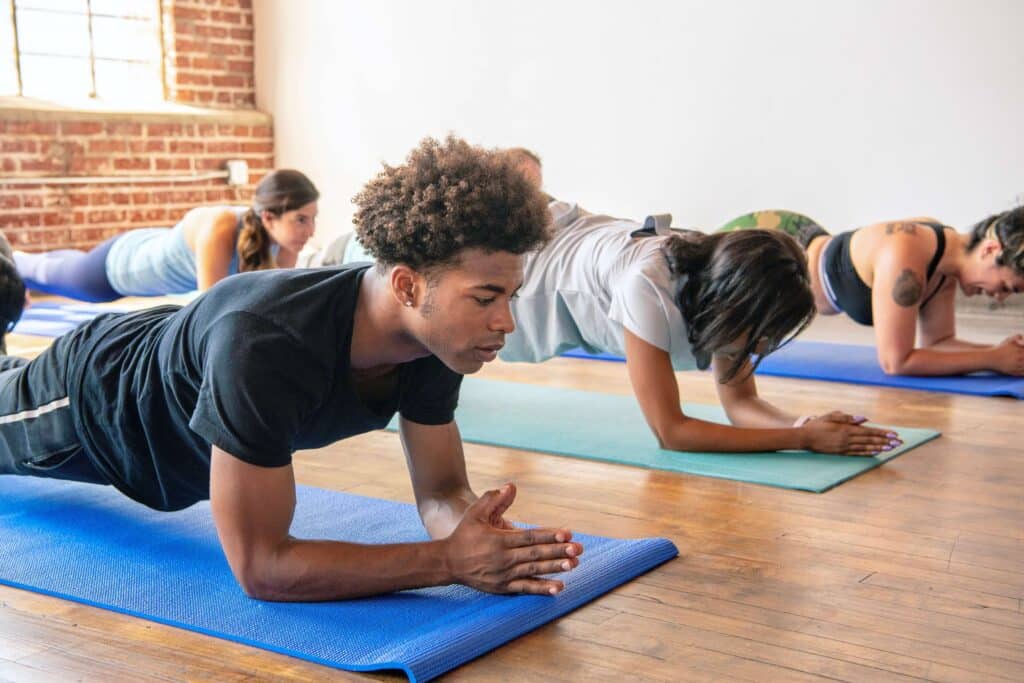 A diverse group of individuals practicing yoga on mats fostering physical and mental well-being